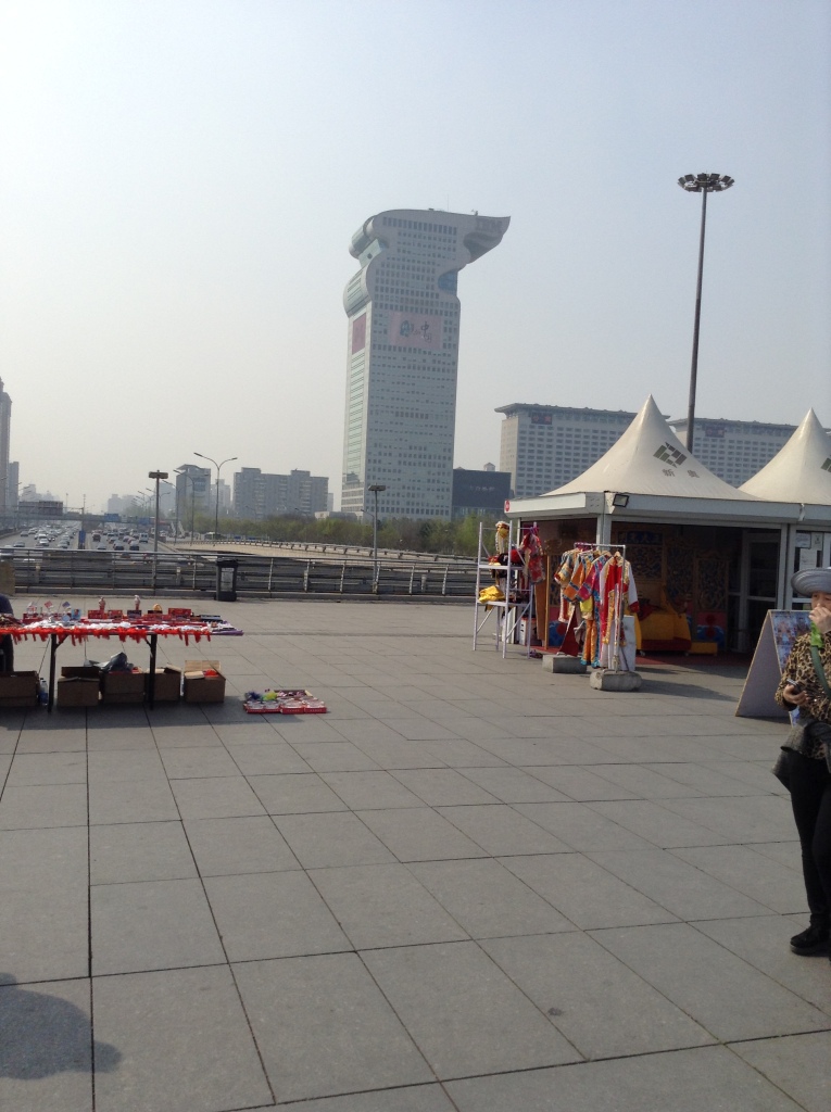 Notice the tents with trinkets for visitors. In the background is the 25-story IBM building (in the shape of Olympic torch)